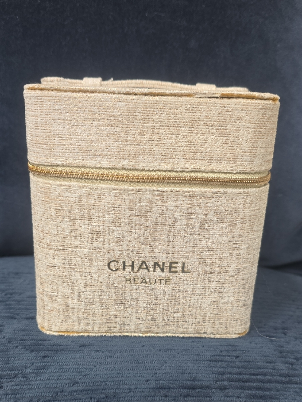 CHANEL beige textured makeup case with gold logo